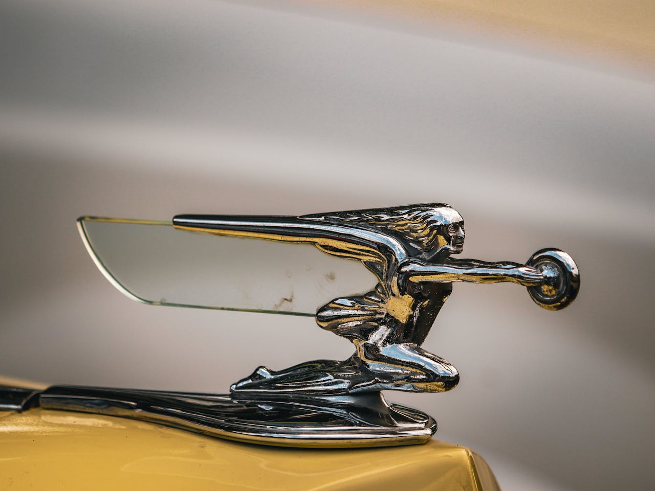 Close-up of a Silver Figurine on a Car